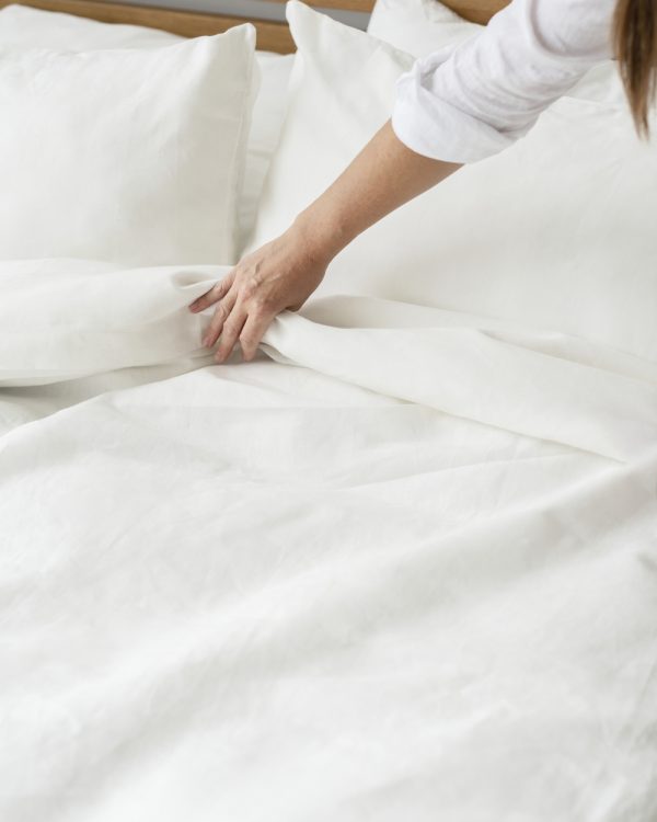 Woman making the bed in the morning